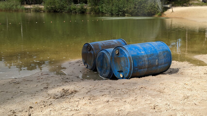 water pollution and environmental pollution by dumping blue waste in this case Drums in the water