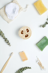 Natural organic eco cosmetics. Soap Eco, reusable cotton pads, loofah natural sponge washcloth, cotton swab, eucalyptus leaves on white background. Flat lay, top view