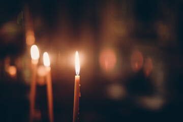burning candles in the night - obrazy, fototapety, plakaty