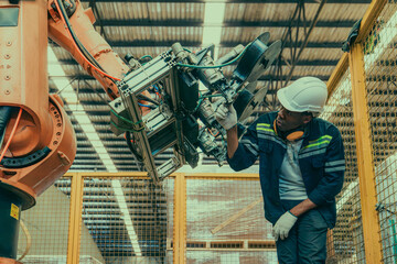 A wood manufacturing robotic technician manage robot arms for productivity, safety, and efficiency.
