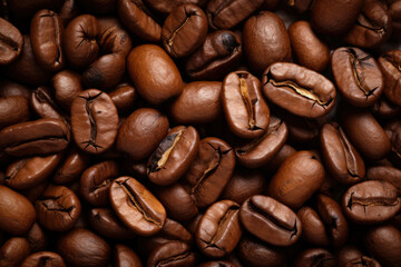 Fototapeta premium Coffee beans in a captivating close-up, showcasing their intricate texture and rich aroma, providing a magnified view that reveals the essence of the coffee culture and the art of brewing.