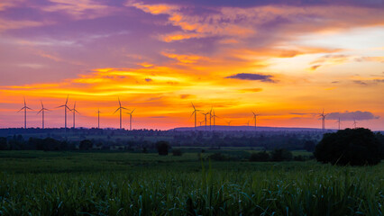 Landscape Windmill on a mountain with vast meadows at sunset, beautifully illuminated.