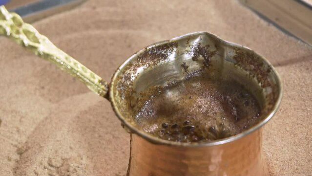 Turkish coffee on sand,Slow motion close up
