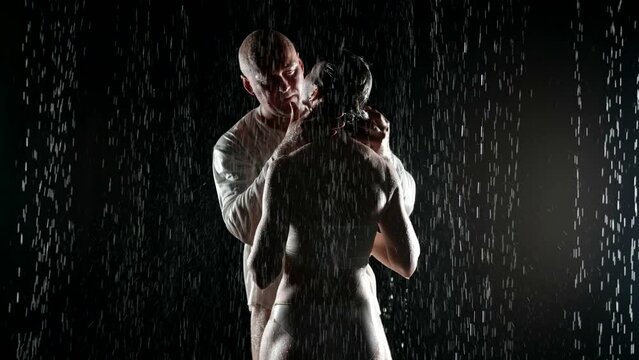 middle-aged bald man seducing young woman, kissing her passionately in rain, sexy female body