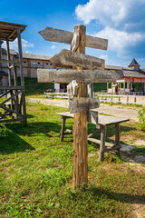Ancient direction sign on a wooden post.