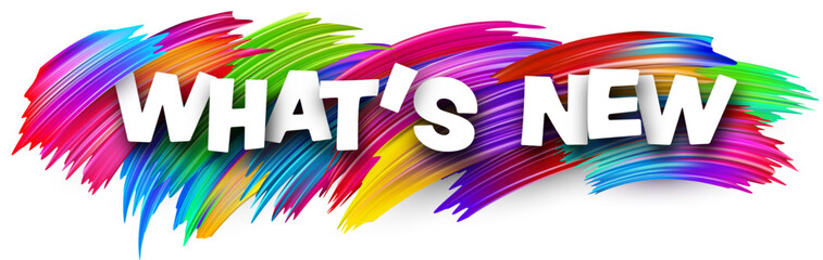 What's new paper word sign with colorful spectrum paint brush strokes over white.