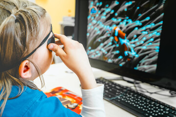 Little girl in medical office undergoing advanced laser vision treatment, correction for eyes...