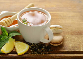 natural tea in a cup with fresh berries and mint
