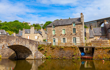 panoramic view of old stone bridge and historical medieval houses reflecting in La Rance river in...