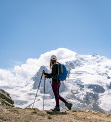 Young women embark on a thrilling alpine adventure, scaling the Swiss Alps, surrounded by awe-inspiring peaks and pristine wilderness.