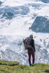 Young women embark on a thrilling alpine adventure, scaling the Swiss Alps, surrounded by awe-inspiring peaks and pristine wilderness.