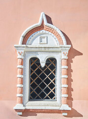 Antique window with wrought iron bars. The Old Palace