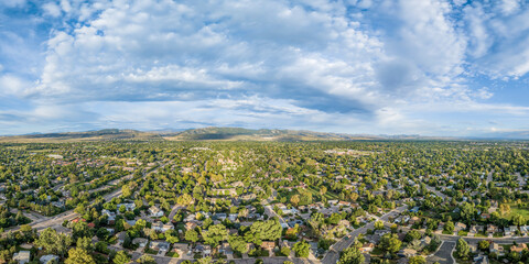residential area of Fort Collins and Rocky Mountains foothills in northern Colorado, aerial panorama view in late summer scenery