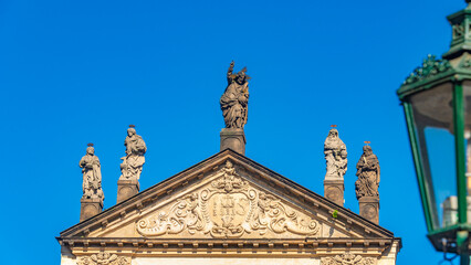 Beautiful Saint Salvator church near Charles Bridge in Prague, Czech Republic, summer time, details, at blue sky and ancient street light