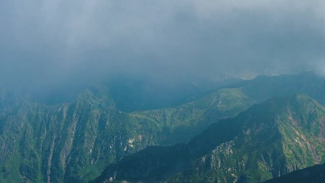 Beautiful mountain landscape. High-mountain massif, clouds over mountain peaks.