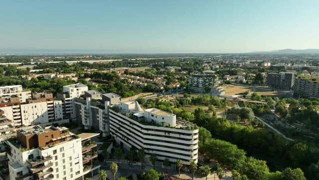 Elevated capture of Montpellier's river, flowing gracefully alongside the architectural wonders of Port Marianne.



