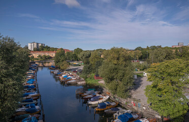 Fototapeta na wymiar Old custom canal Pålsundet with veteran boats moored, cumulus clouds, a sunny autumn day in Stockholm