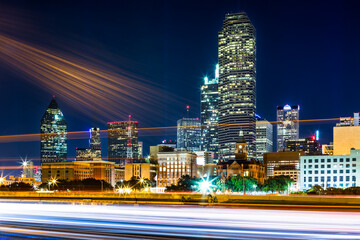 Dallas skyline by night with long exposure traffic trails and lens flares on Interstate 35E