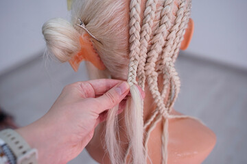 Artificial material for weaving African braids, colored kanekalon lies on the table, different materials for afro braids