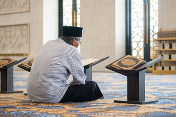 Muslim old man reading holy Quran. Islamic concept