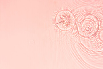 Pink transparent water texture with circles from drops