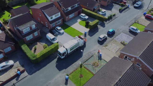 Drone. Waste collection truck in urban street collecting trash. Filmed. Yorkshire.UK. 