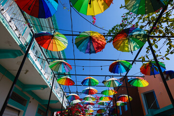 Fototapeta na wymiar Colorful umbrella decoration-A street decorated with colorful umbrellas in Puerto Plata, Dominican Republic