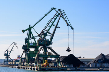 A harbor crane loads coal in the port of Gdynia, Poland