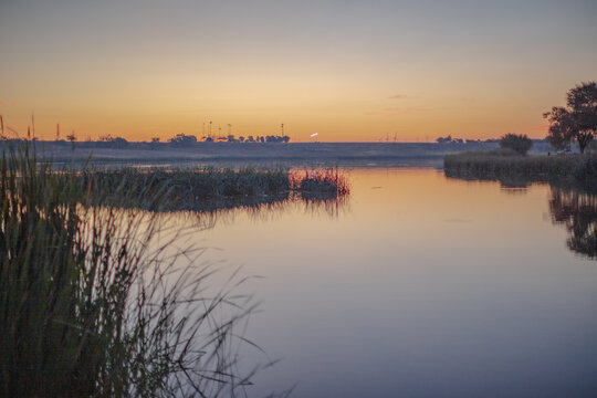Landscape photo at Dunbar Historical Lake Lubbock Texas of sunrise over water