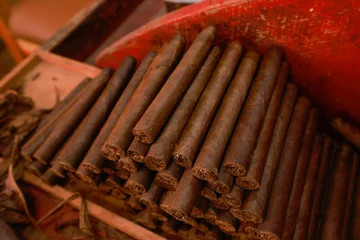 Zelfklevend Fotobehang Closeup on stacked hand-rolled cigars. © AJITH.A
