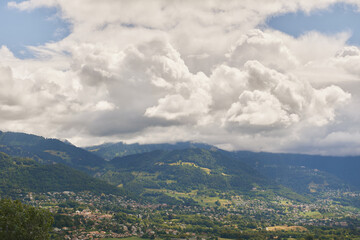 Fototapeta na wymiar Beautiful summer mountain landscape with fluffy clouds, image taken in canton of Vaud, Switzerland