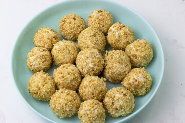 An appetizer for the festive table. Aperitif. Cheese balls in peanut crumbs