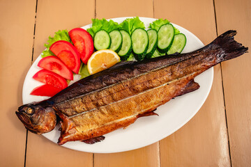 Grilled trout with vegetables.