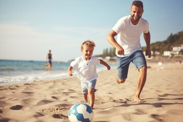 Young father with his little son playing football on the beach sea, sunny day, summer