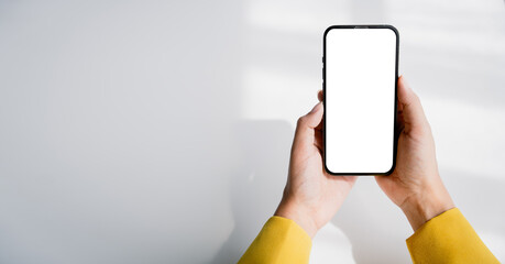 Close-up of a young woman holding a smartphone, typing a message, talking with friends. on social networks Concept of using mobile application, online shopping, opening website, ordering food, busines