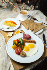 English breakfast with vegetable salad include tomato, potato, lettuce leaf and carrot with tea, coffee, and sweet melon served on food table top view healthy breakfast