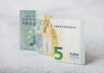Five euro banknote close up on light background. Economy crisis concept.