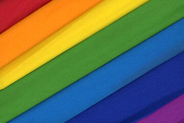 Colorful crepe rolls abstract background. 7 rolls of crepe paper diagonally. In the colors of the rainbow.
