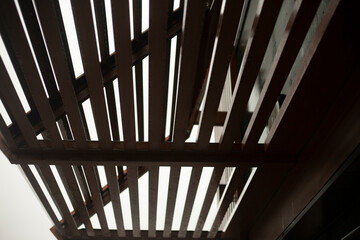 Roof is made of wood. Corner of boards. Building building. Ribbed surface.