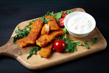 fried fish nuggets, with white sauce, arugula and cherry, no people,