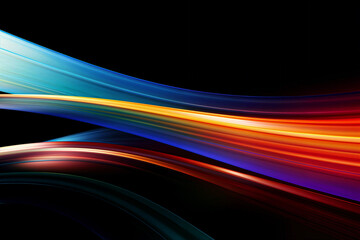 Abstract image of bright colored light streaks of red, orange and blue in motion on a black background
