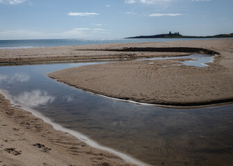 Low Newton, UK - 13 July, 2023: Views of Dunstanburgh castle and the Northumbria coast, Low Newton...