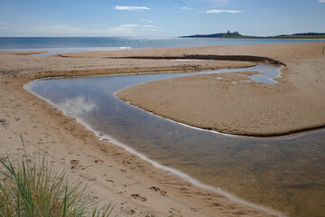Low Newton, UK - 13 July, 2023: Views of Dunstanburgh castle and the Northumbria coast, Low Newton...
