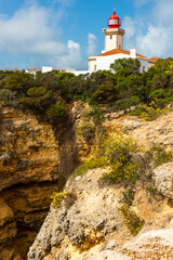 Fototapeta na wymiar Farol de Alfanzina Lighthouse in Algarve Coast, Portugal