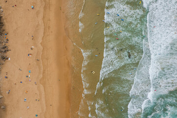 Surf on Altantic Ocean waves, Algarve, Portugal. Aerial drone view