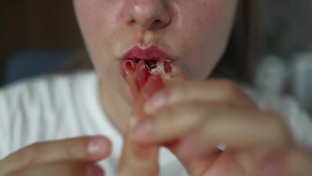 Close up portrait of young woman eating jamon traditional spanish dry-cured ham at home