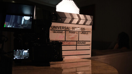 Camera and clapperboard behind the camera. Clapperboard and camera before shooting the scene