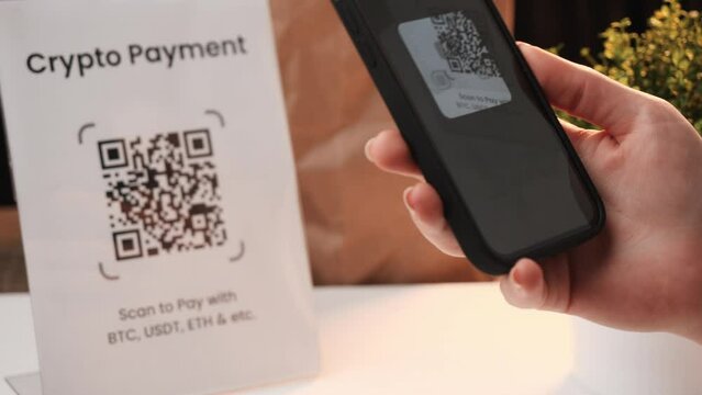 QR code crypto currency payment. Using a smartphone app, scan a QR code and pay with cryptocurrency for shopping.