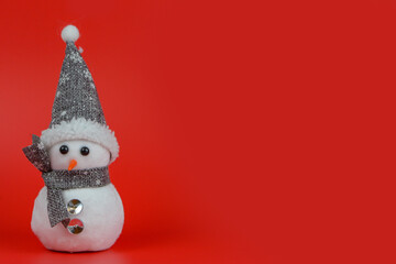 Christmas composition. cheerful snowman on a red background. New Year concept with place for text