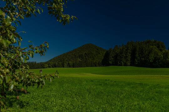 Green meadow with blue sky near Ebenau village in summer sunny day